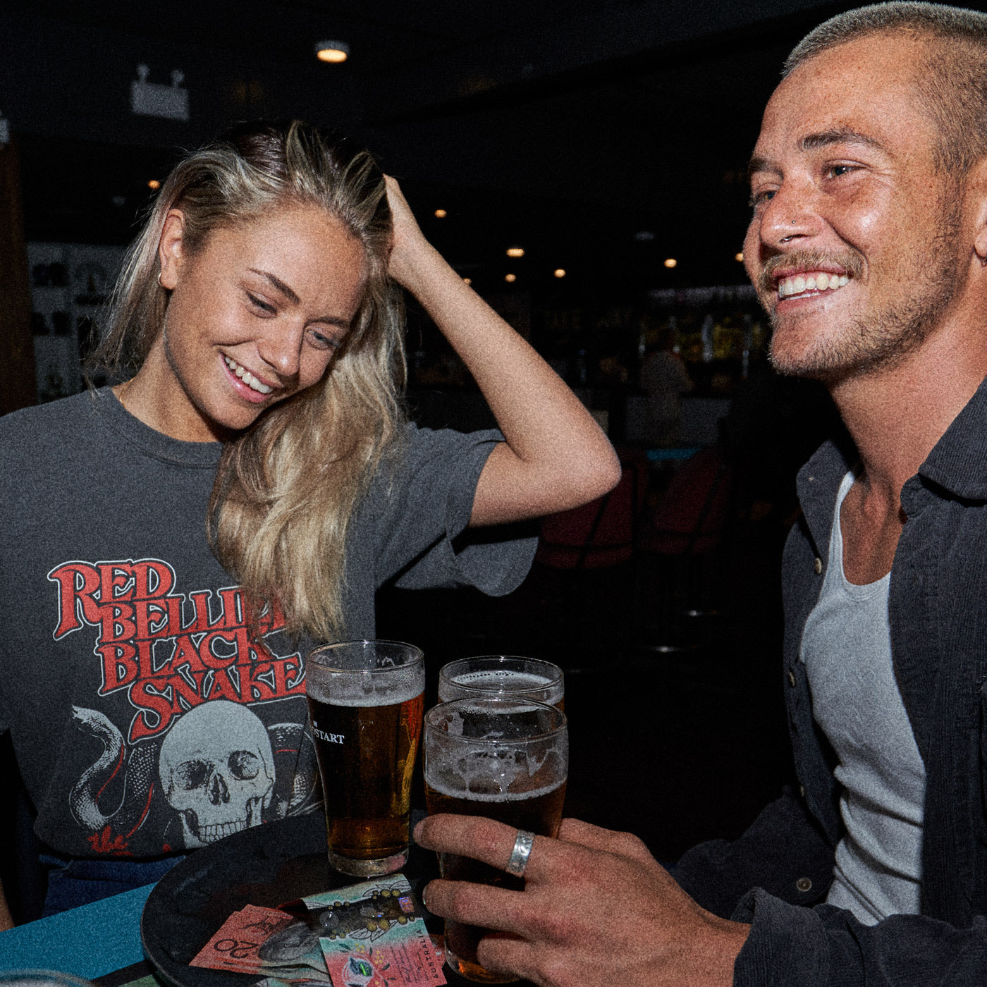 A man and woman having a good time in The Beefs Red Bellied Black Snake t-shirt