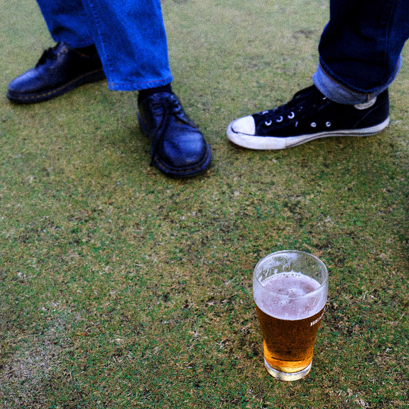 Feet with half a schooner in front of them at the Bowlo