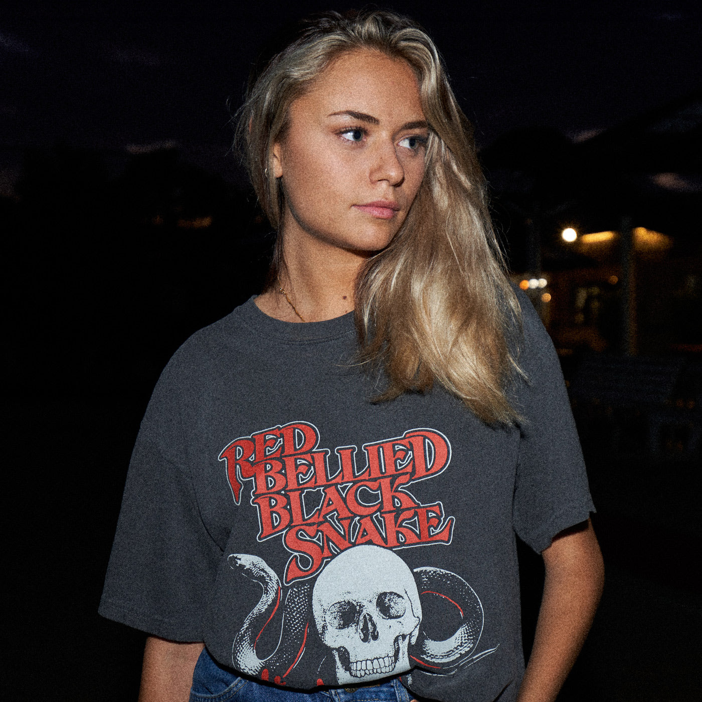 A photo of a young Australian woman at the pub in a Red Bellied Black Snake t-shirt