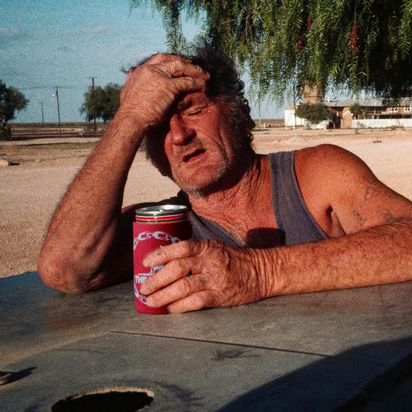 A weathered old man in country Australia holding a Beef Sleeve