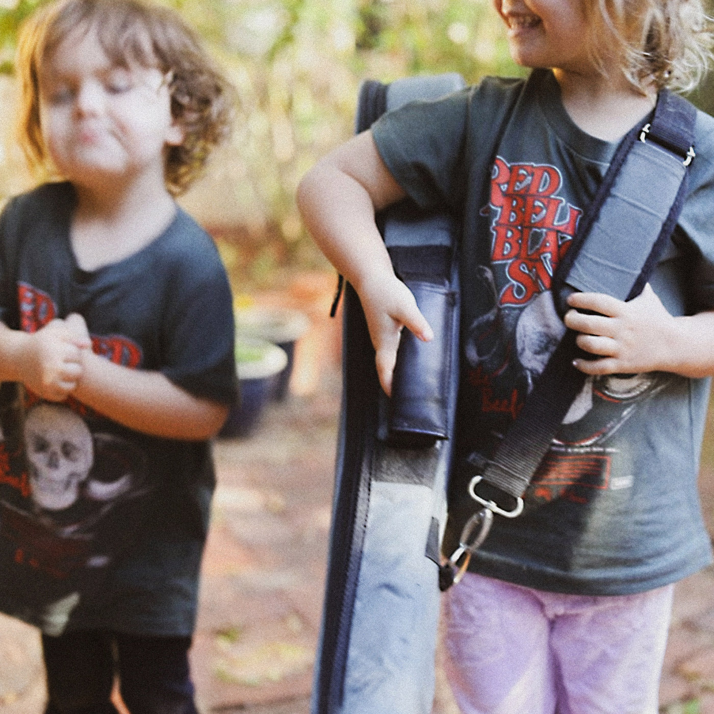 Children carrying a surfboard and wearing The Beefs RBBS kids tee